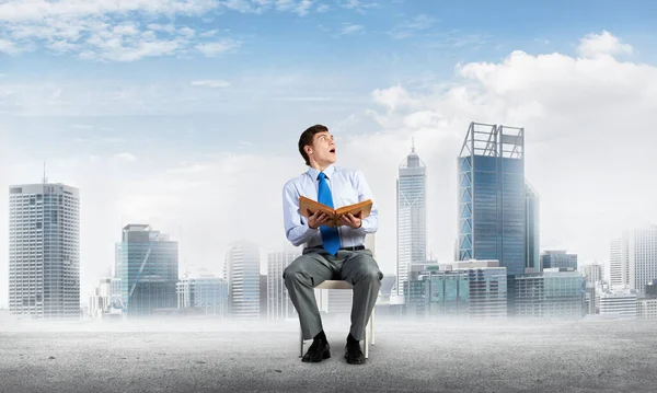 Young businessman with book — Stock Photo, Image