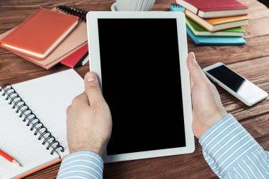 Tabletli bir işadamı, ofiste çalışıyor.