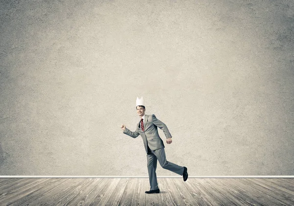 King businessman in elegant suit running in empty room — Stock Photo, Image