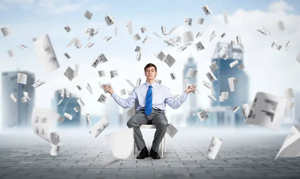 Businessman meditates on office chair — Stock Photo, Image