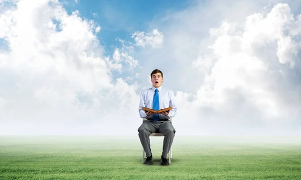 Young businessman with book — Stock Photo, Image