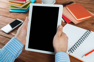 Tabletli bir işadamı, ofiste çalışıyor.
