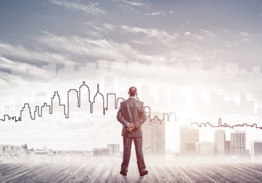 Motivasyon ve ilham konsepti modern şehir manzarası ve onu izleyen iş adamı