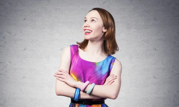 Smiling woman standing with folded arms — Stock Photo, Image