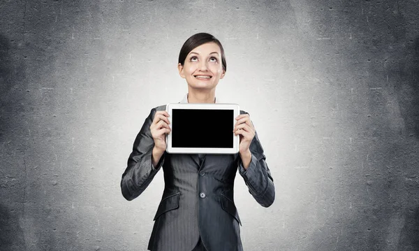 Businesswoman with tablet computer looking upwards — Stock Photo, Image