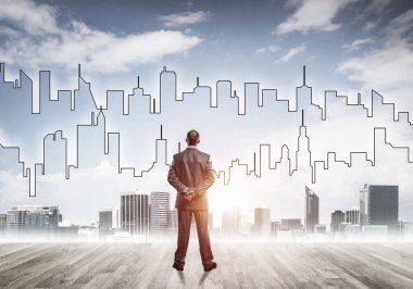 Motivasyon ve ilham konsepti modern şehir manzarası ve onu izleyen iş adamı