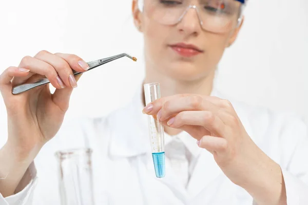 Young female research scientist puts sample — Stock Photo, Image