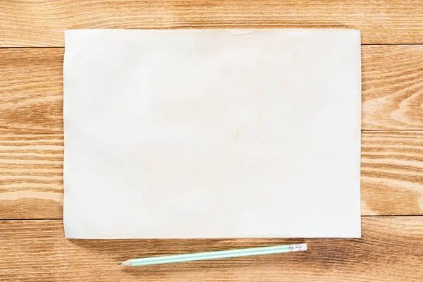 Sheet of paper lying on wooden table Stock Image