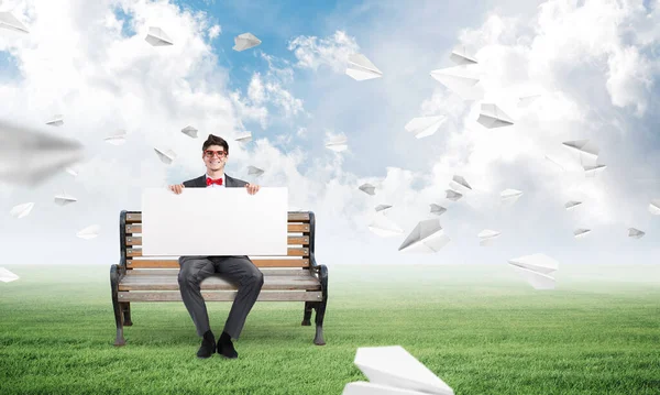 Young businessman with an empty poster Stock Image