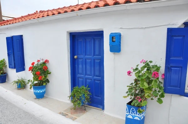 Casa típica griega, fachada blanca y ventanas y puertas azules — Foto de Stock