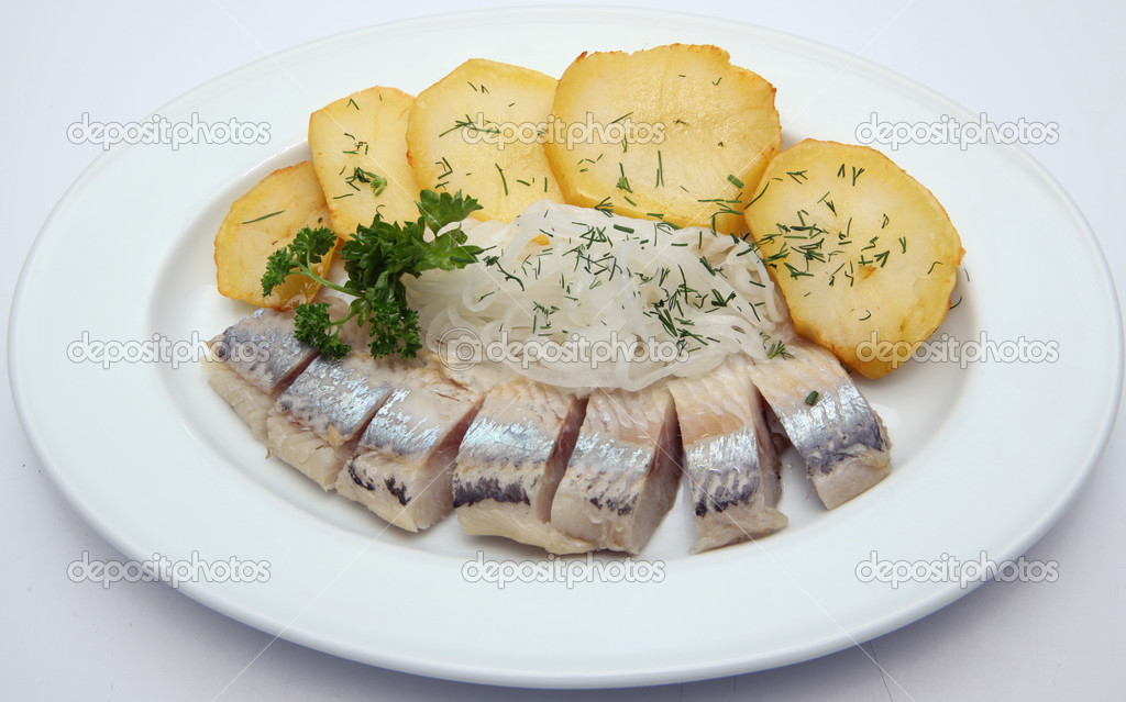 Herring, potatoes grilled, marinated onions Stock Photo by ©scworets