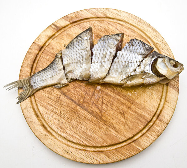 Dried fish on wooden plate