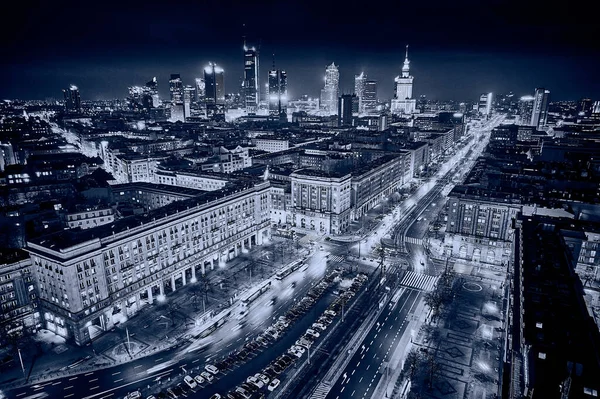 Constitution Square (PL: Plac Konstytucji) - a view of the center of night Warsaw with skyscrapers in the background - the lights of the big city by night, Poland, EU.