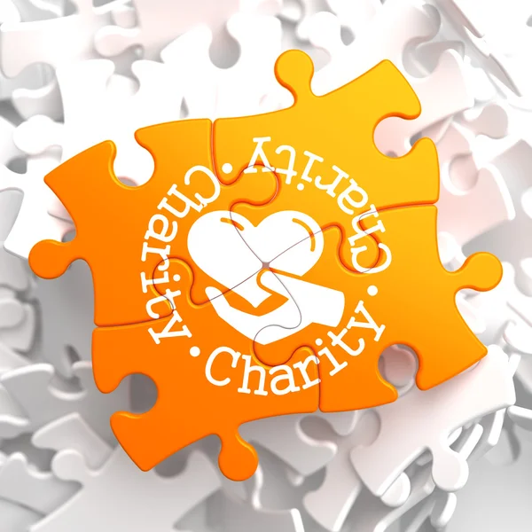 Charity Concept on Orange Puzzle. — Stock Photo, Image