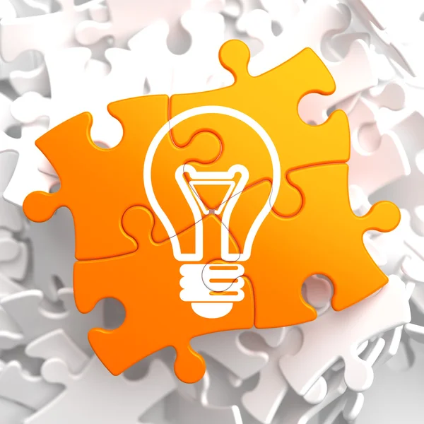 Light Bulb Icon on Orange Puzzle. — Stock Photo, Image