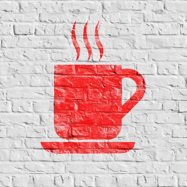 Coupe rouge de café icône sur mur de brique blanche . — Photo