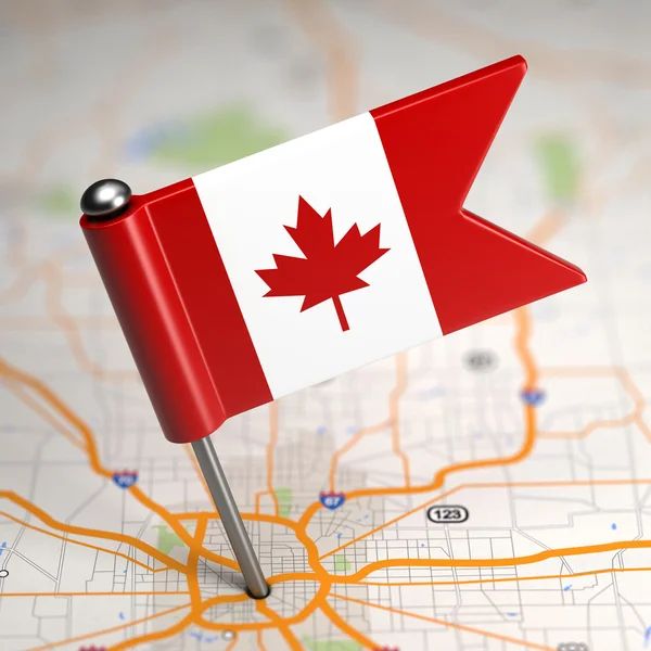 Mała flaga Kanady na tle mapy. — Zdjęcie stockowe