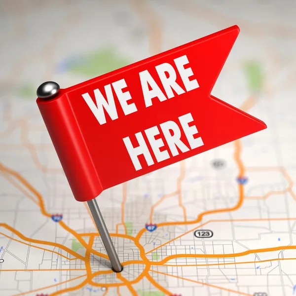 We Are Here - Small Flag on a Map Background. — Stock Photo, Image