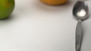 Sunbae, şeffaf cam bir tatlı kasesi tutuyor... ginkgo meyveli pirinç topları ve hindistan cevizi sütlü hindistan cevizi eti ve beyaz masaya koyuyor..