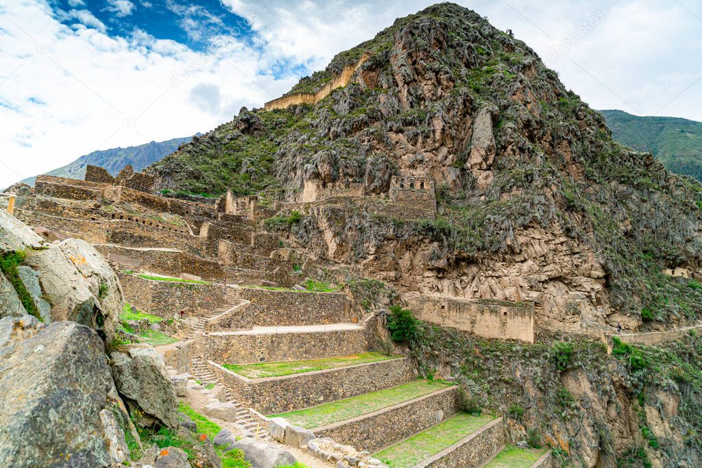 View of agricultural terraces and ruin building on the mountain in Inca Archaeological site at Ollantaytambo, Peru.