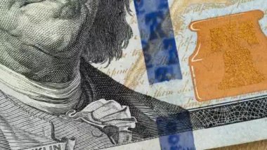 Closeup view of one hundread dollar bill in Stop Motion. Time lapse texture of one hundread USD. Macro shot of 100 US Dollar.