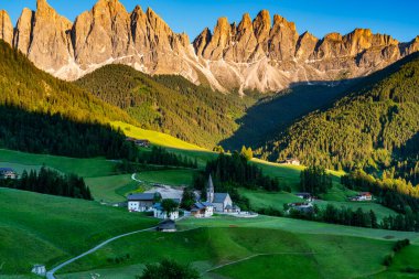 Evening light in Funes Valley or Val di Funes with the Odle Peak in the Italian Dolomite and The Famous Church of St. Magdalena in South Tyrol, Italy.