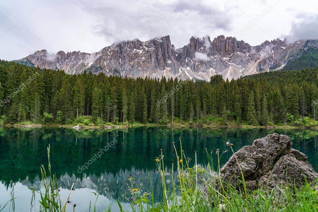 Landscape of Rainbow Lake Carezza in the Dolomites of the Val d'Ega with Mount Latemar in the background.