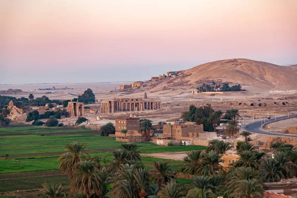 Landscape of Valley of The Kings in the morning at Theban Necropolis with The Temple of Ramesseum for Pharaoh Ramses II and the green crop of the village, Luxor, Upper Egypt.