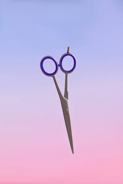 Barber scissors on a gradient blurred background in the air — Stockfoto