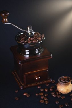 Kahve öğütücüsü, siyah arkaplanda kahve çekirdekleri..