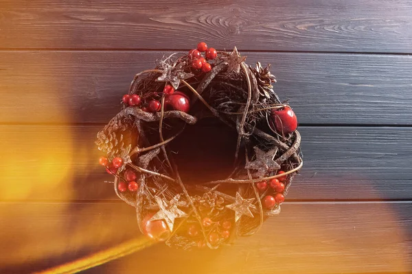Designer christmas wreath on black wooden background.