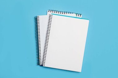 Blank notebooks on a light blue background