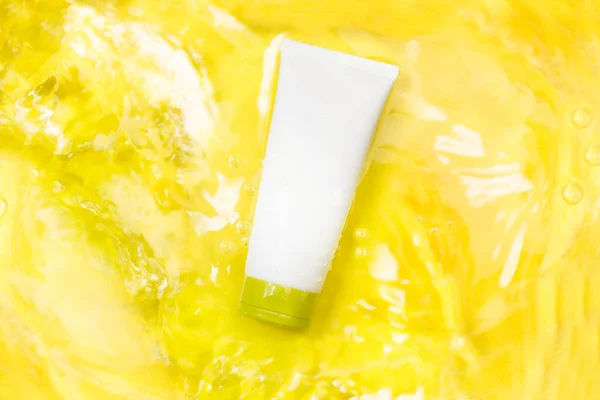 Moisturizer Cream Soft Tube Water Yellow Background Top View — Fotografie, imagine de stoc