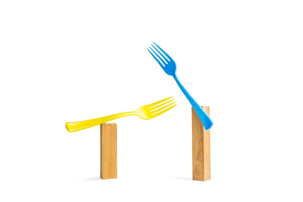 Blue Yellow Plastic Forks Wooden Bricks White Background Copy Space — Photo