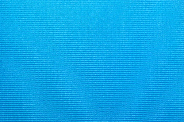 Texture of a blue yoga mat in a close up view