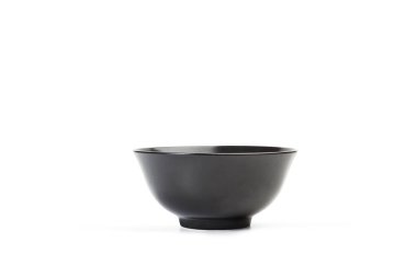 Black ceramic bowl on a white background with copy space