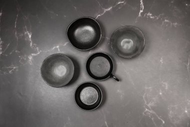 Cermic bowls on a gray marble kitchen counter in a top view