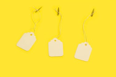 Three blank white carton labels on a yellow background with copy space