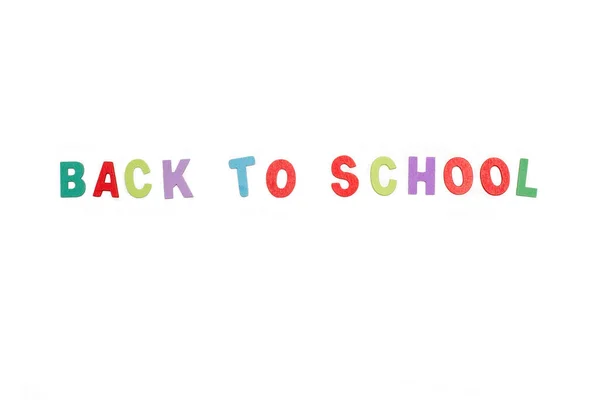 Back to school write with colored toy letters on a white background with copy space