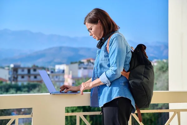 Уверенная в себе серьезная зрелая деловая женщина с ноутбуком на открытом воздухе. — стоковое фото