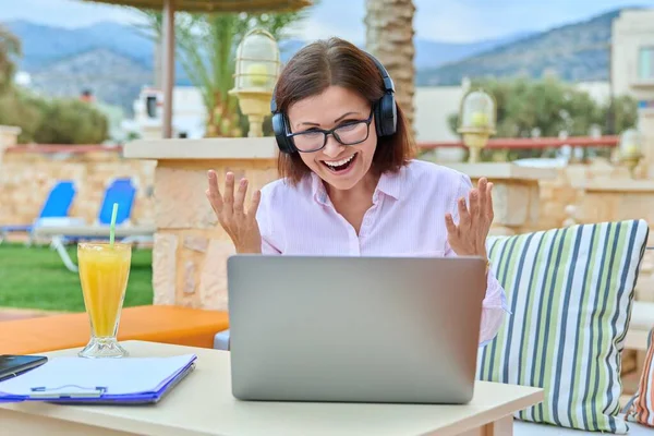 Donna con le cuffie guardando computer portatile, parlando, utilizzando la videochiamata. — Foto Stock