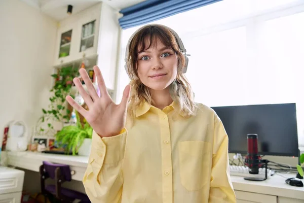 Teenager-Studentin mit drahtlosem Kopfhörer spricht in die Kamera — Stockfoto