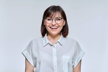 Headshot portrait of smiling middle aged woman looking at camera