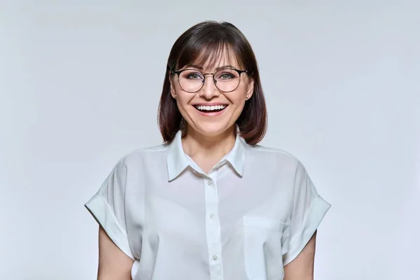 Headshot portrait of smiling middle aged woman looking at camera — Stok fotoğraf