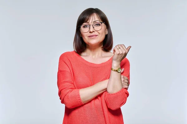 Portrait of middle aged woman looking at camera, on light studio background — Stock Fotó