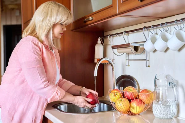 Mature Woman Washing Apples Home Kitchen Beautiful Senior Female Sink — стоковое фото