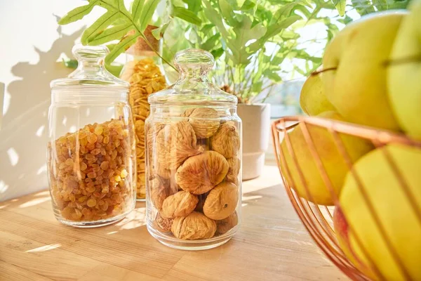 Dry fruits in a jar, figs, raisins, apples. Food storage in the kitchen, household