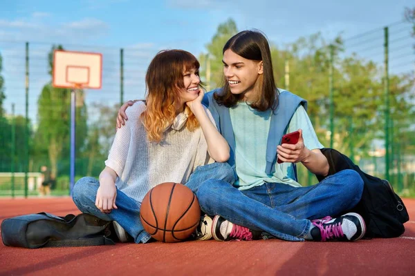 Couple Teenage Student Friends Sitting Outdoor Basketball Court Ball Backpacks — Photo