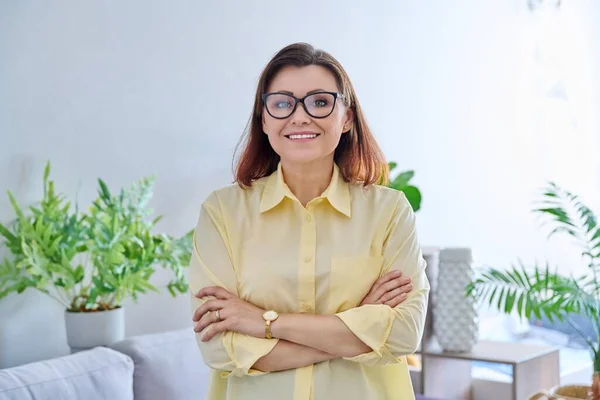 Portrait of confident middle aged business woman in office. Female psychologist, advisor, specialist, manager with crossed arms looking at camera. Job, profession, therapy, mature people concept