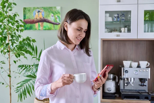 Young Woman Relaxing Resting Home Kitchen Cup Coffee Using Smartphone — Photo